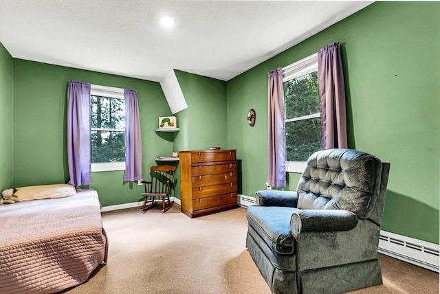 carpeted bedroom with a baseboard heating unit and baseboards