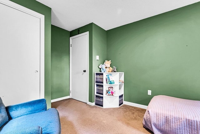 bedroom featuring baseboards and carpet flooring