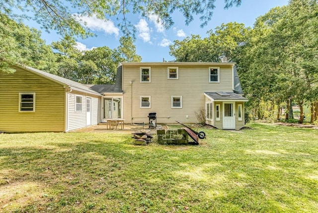 rear view of property with a patio area and a lawn