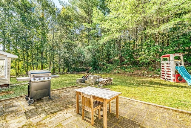 view of patio with a grill and a playground