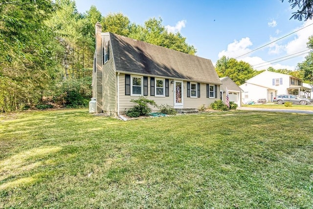 view of front of home with roof with shingles, a front lawn, and a chimney