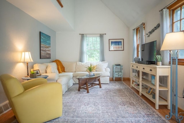 10 Kellies Path, Eastham, MA 02642 - living area featuring plenty of natural light, wood finished floors, and high vaulted ceiling