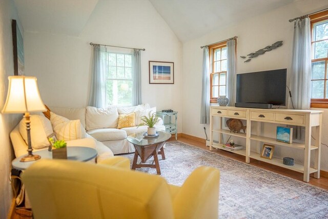 10 Kellies Path, Eastham, MA 02642 - living area featuring wood finished floors and vaulted ceiling