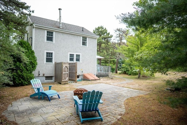 10 Kellies Path, Eastham, MA 02642 - rear view of property featuring an outdoor fire pit, a patio, and a deck