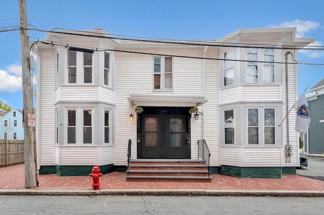 view of front of house featuring entry steps and fence