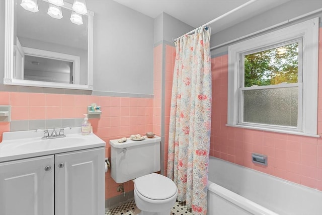 299 Appleton St, Arlington, MA 02476 - full bathroom with vanity, tile walls, shower / bath combo, and a wainscoted wall