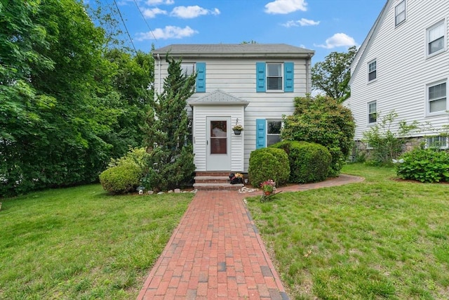 299 Appleton St, Arlington, MA 02476 - traditional-style home featuring entry steps and a front yard