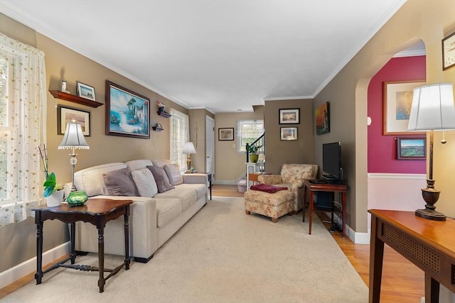 299 Appleton St, Arlington, MA 02476 - living area with wood finished floors, crown molding, and arched walkways