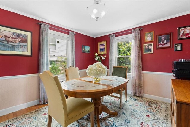 299 Appleton St, Arlington, MA 02476 - dining space with light wood-style flooring and ornamental molding