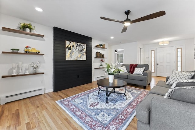 living area with a baseboard radiator, recessed lighting, light wood-style flooring, a baseboard heating unit, and a ceiling fan