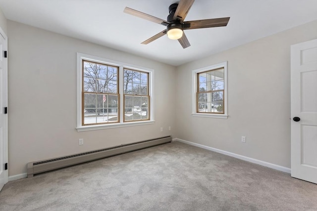 carpeted empty room with baseboards, baseboard heating, and a ceiling fan