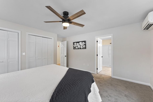 bedroom with baseboards, light colored carpet, two closets, and an AC wall unit