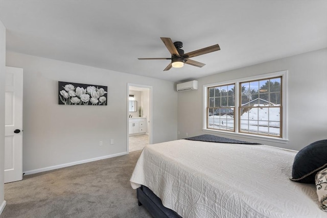 bedroom with baseboards, connected bathroom, a wall unit AC, ceiling fan, and carpet flooring