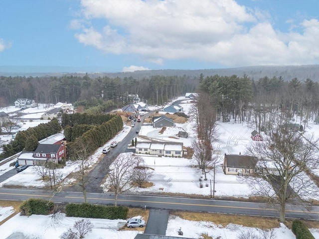 snowy aerial view with a forest view