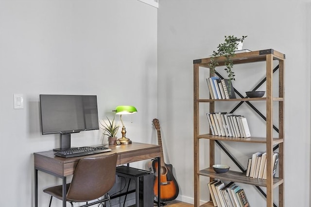 office space with baseboards and wood finished floors