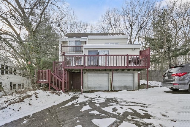 view of front of house with a garage and a deck