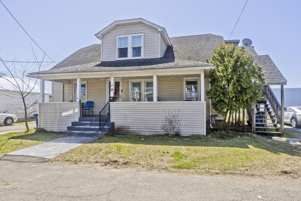 bungalow-style home featuring covered porch, a shingled roof, stairs, and a front lawn