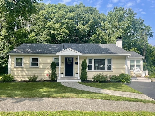 277 Ridgewood Dr, Norwood, MA 02062 - view of front of home featuring a chimney, a front yard, and roof with shingles