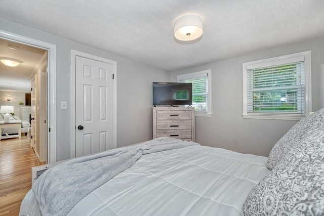277 Ridgewood Dr, Norwood, MA 02062 - bedroom with wood finished floors and a textured ceiling