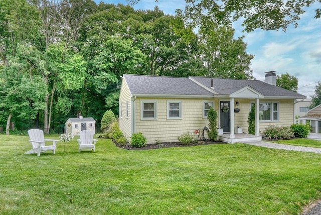 277 Ridgewood Dr, Norwood, MA 02062 - view of front of home with a chimney, a front yard, a storage unit, and roof with shingles