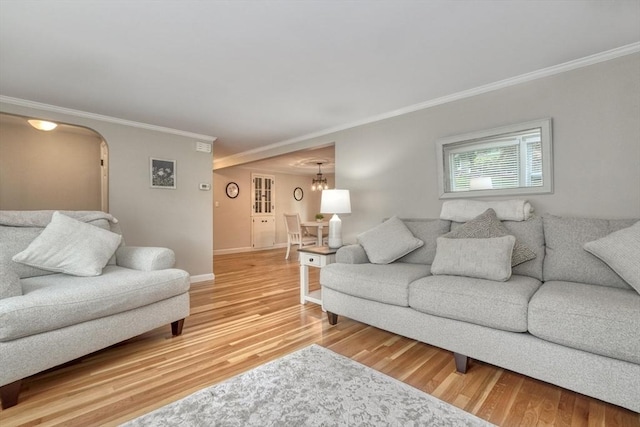277 Ridgewood Dr, Norwood, MA 02062 - living area featuring crown molding, light wood finished floors, and arched walkways