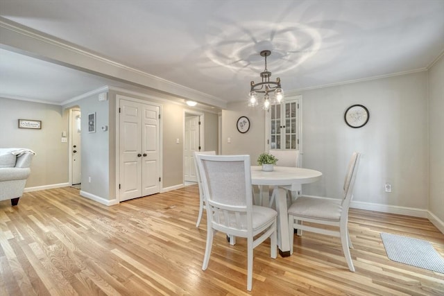 277 Ridgewood Dr, Norwood, MA 02062 - dining space featuring a chandelier, light wood-style floors, and ornamental molding