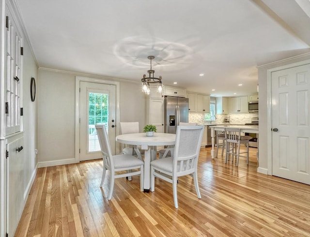 277 Ridgewood Dr, Norwood, MA 02062 - dining space with light wood-style flooring, ornamental molding, recessed lighting, and a chandelier