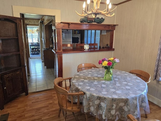 dining space featuring an inviting chandelier and wood finished floors