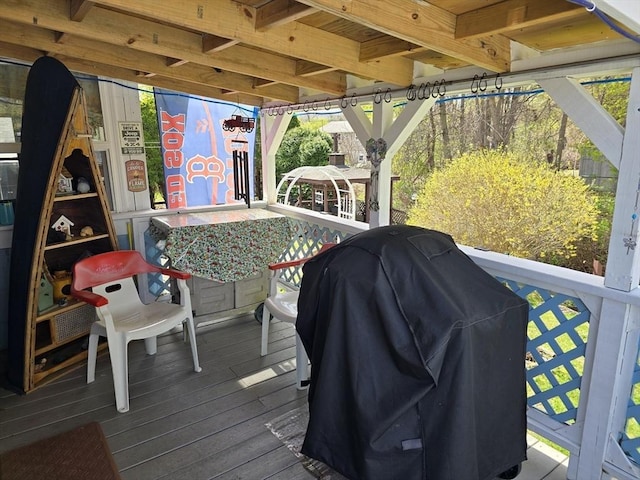 wooden deck featuring area for grilling and a gazebo