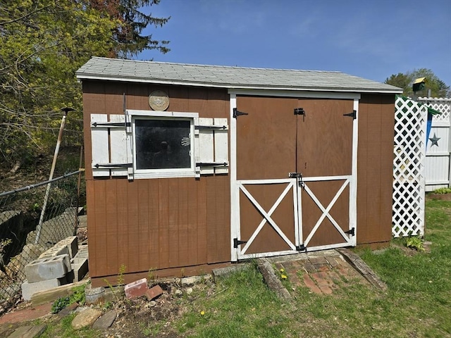 view of shed with fence