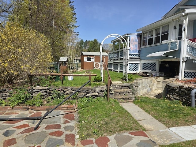 view of yard featuring an outbuilding, stairs, and a storage unit