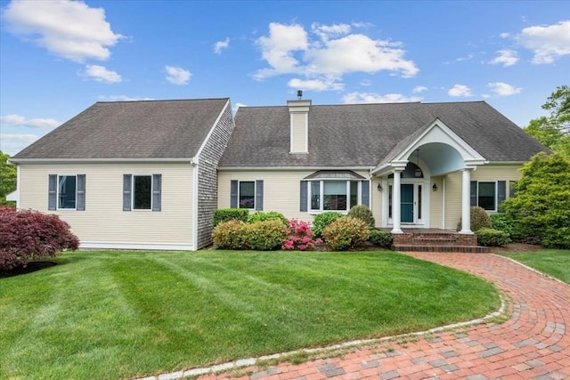 89 Standish Rd, Bourne, MA 02562 - cape cod-style house featuring a chimney, a front yard, and roof with shingles