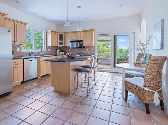 89 Standish Rd, Bourne, MA 02562 - kitchen with stainless steel appliances, light brown cabinets, a kitchen island, decorative backsplash, and recessed lighting