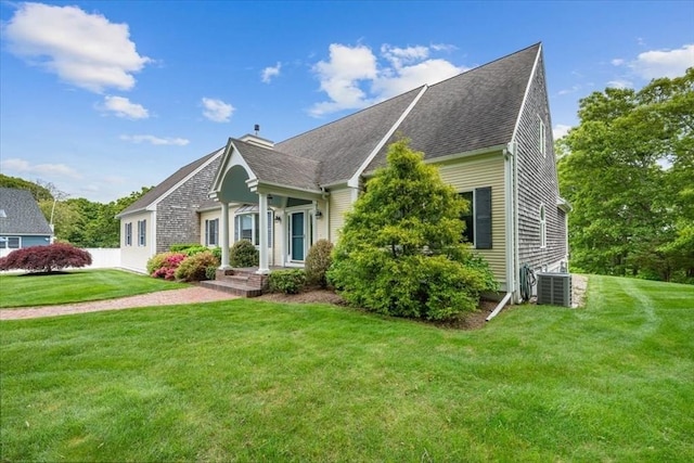 89 Standish Rd, Bourne, MA 02562 - view of front of property with cooling unit, a front yard, and roof with shingles