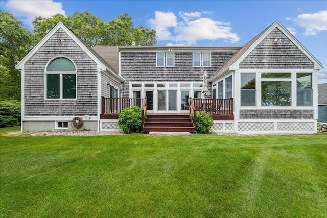 89 Standish Rd, Bourne, MA 02562 - rear view of house featuring a deck, a lawn, and a sunroom