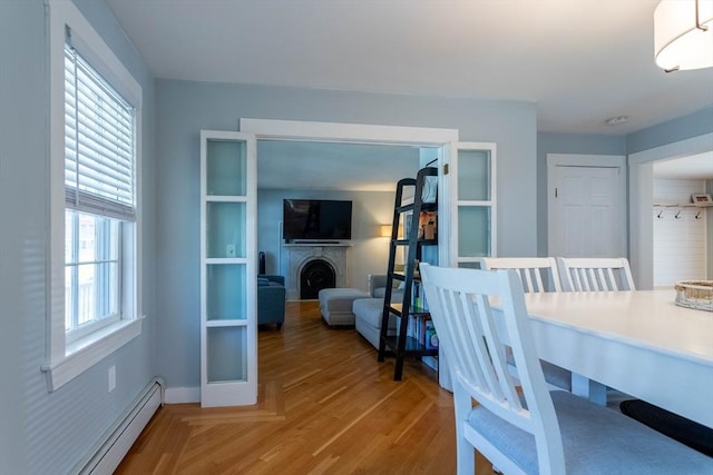 3846 Pawtucket, East Providence, RI 02915 - dining area with a baseboard radiator, light wood-style flooring, and a fireplace