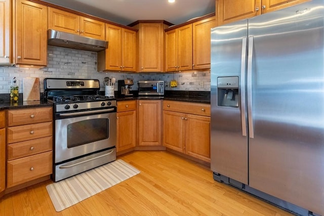 3846 Pawtucket, East Providence, RI 02915 - kitchen featuring stainless steel appliances, under cabinet range hood, light wood-type flooring, brown cabinets, and tasteful backsplash
