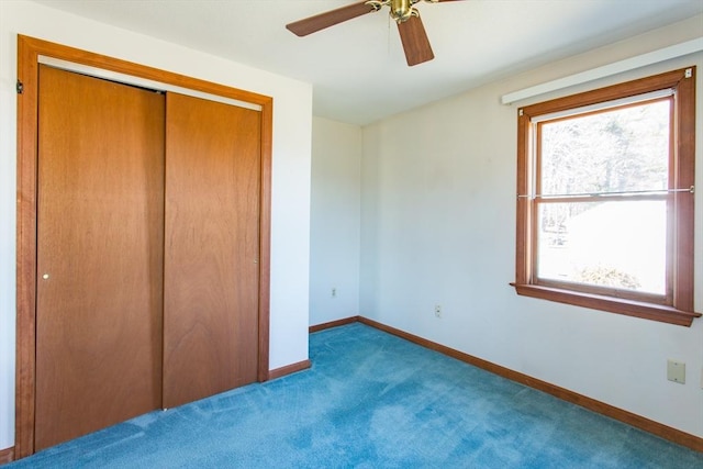 unfurnished bedroom with a closet, ceiling fan, baseboards, and carpet