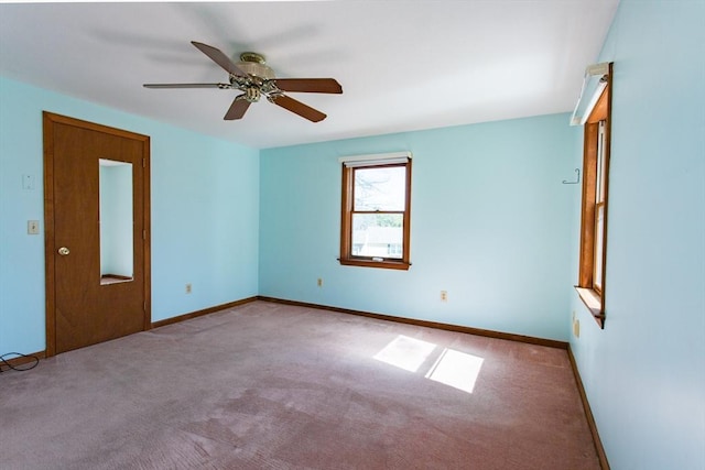 spare room featuring baseboards, carpet flooring, and ceiling fan