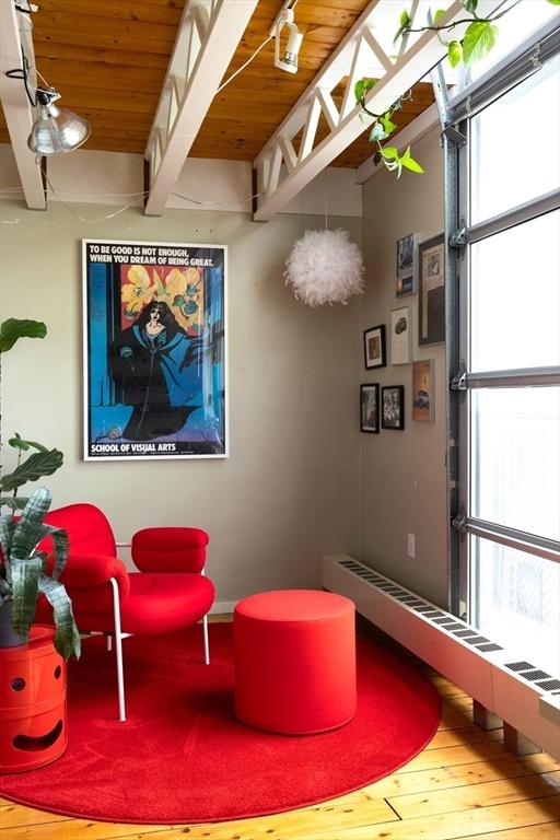 playroom featuring healthy amount of natural light, wood-type flooring, wood ceiling, beam ceiling, and a baseboard radiator