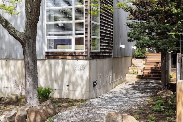 view of side of property featuring stairs