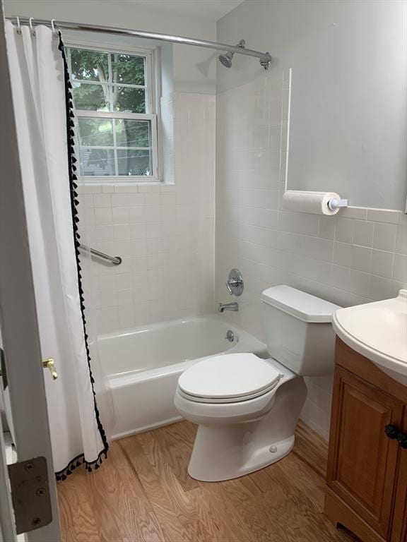 5 Woodsum Dr Unit 7, Braintree, MA 02184 - full bath featuring tile walls, wood finished floors, shower / tub combo with curtain, toilet, and vanity