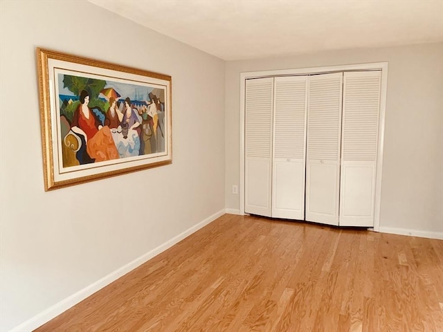 5 Woodsum Dr Unit 7, Braintree, MA 02184 - unfurnished bedroom with light wood-style floors, baseboards, and a closet