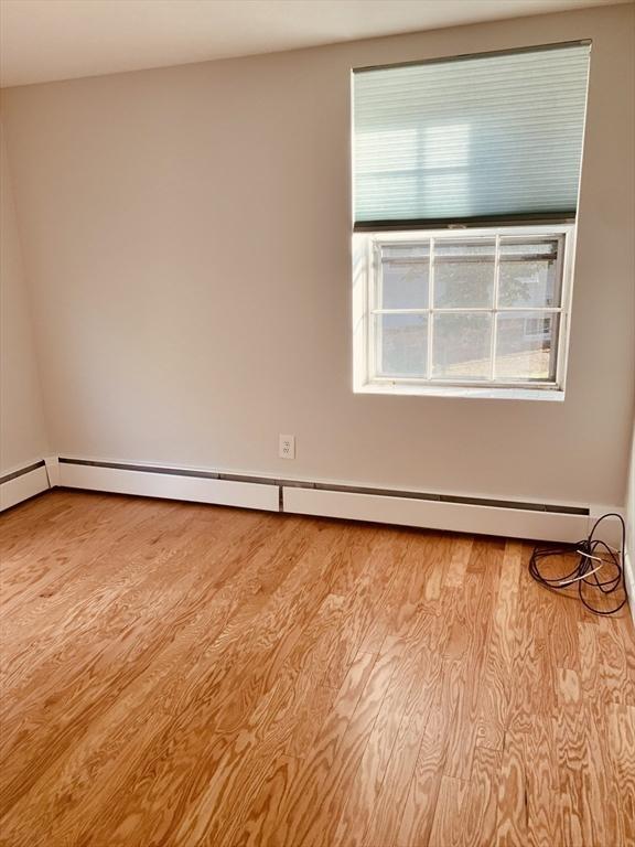 5 Woodsum Dr Unit 7, Braintree, MA 02184 - unfurnished room with baseboard heating and light wood-style floors