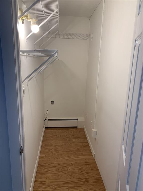5 Woodsum Dr Unit 7, Braintree, MA 02184 - spacious closet with a baseboard heating unit and wood finished floors