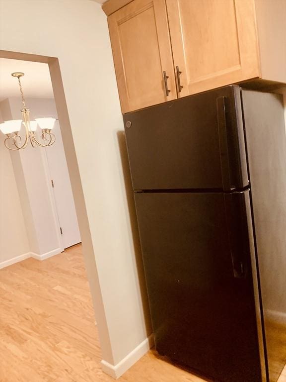 5 Woodsum Dr Unit 7, Braintree, MA 02184 - kitchen with freestanding refrigerator, light wood-style flooring, a chandelier, baseboards, and decorative light fixtures
