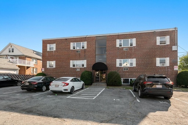 view of building exterior with uncovered parking