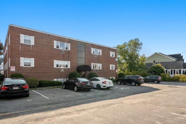 view of property featuring uncovered parking