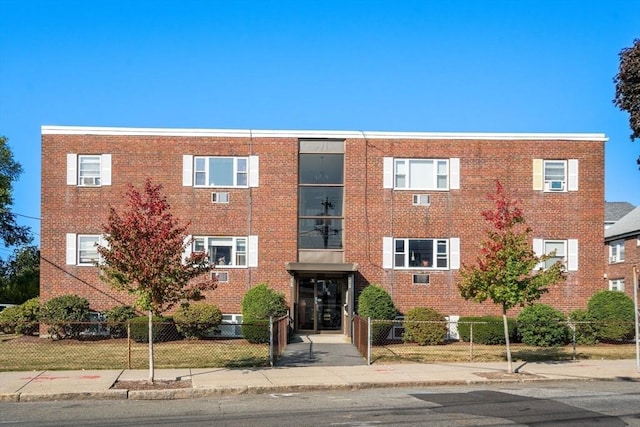 view of building exterior with a fenced front yard