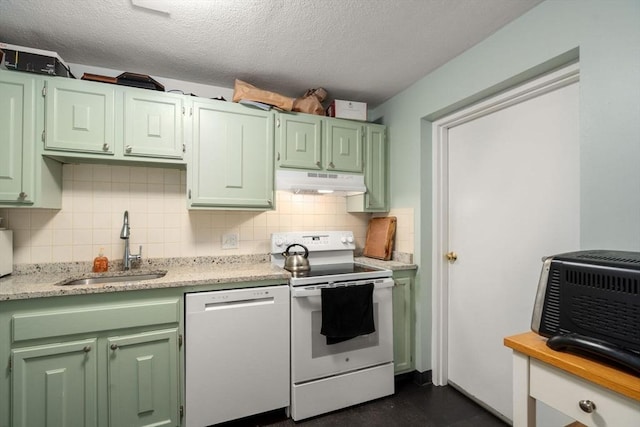 kitchen with a sink, white appliances, under cabinet range hood, and green cabinetry